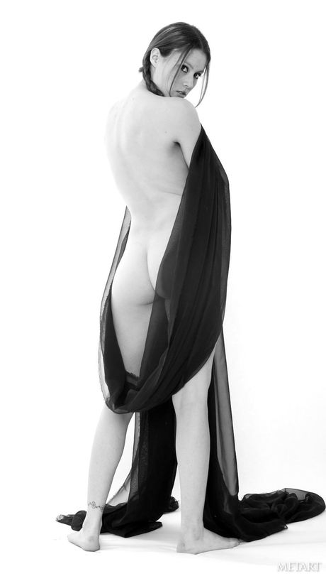 Lean teen Jassie A gets naked in pigtails and a tattoo on her arm