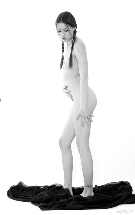 Lean teen Jassie A gets naked in pigtails and a tattoo on her arm