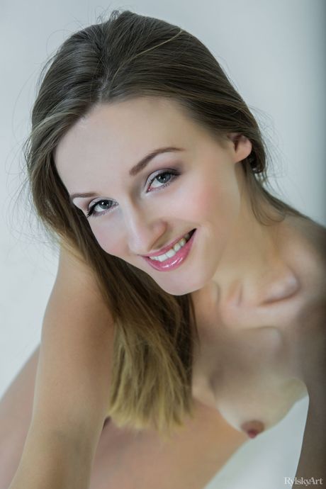 Slender teen Vittoria Amada shows her small tits and poses nude in a solo