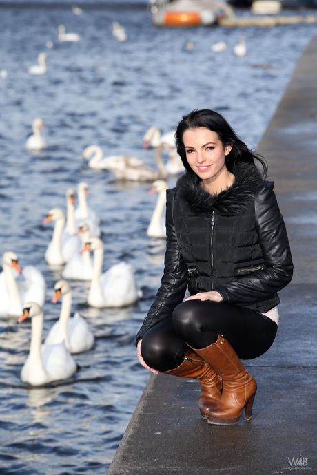 Charming teen Sapphira A bares her body in a pair of boots while in a window