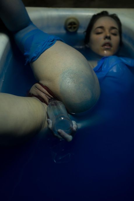 Teen model Emily J removes her pantyhose to pose nude in the bathroom