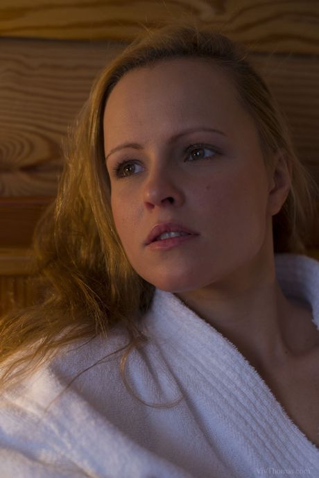 Blonde teen Jo takes off everything before fingering her pussy on a bed