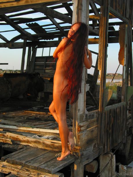 Teen Xeniya B atraente mostra seus peitos grandes e bunda quente enquanto posa nu em rochas
