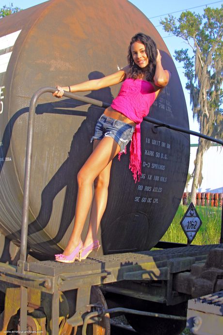 Hot teen with small tits Danica presents her shaved pussy outdoors