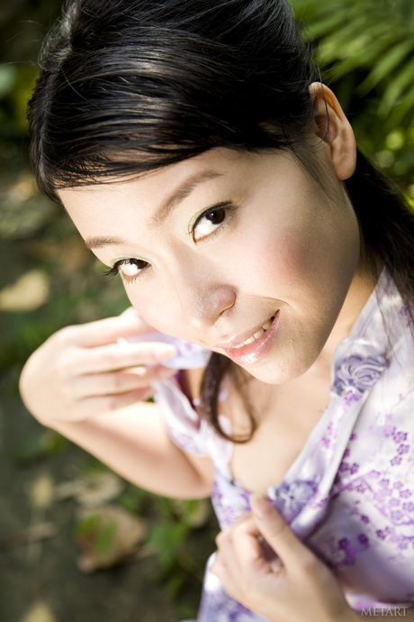 Asian teen Jane Lee takes off everything on a path in a garden