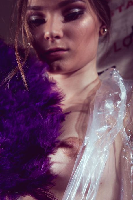 Endearing teen Claudia removes a plastic wrap from her naked body