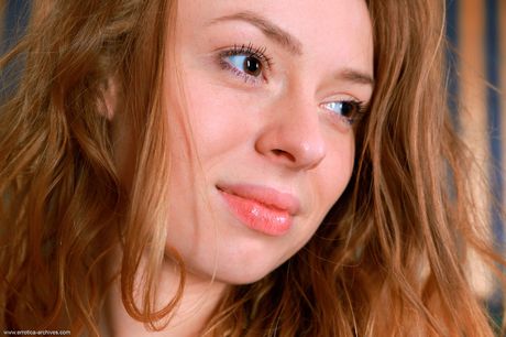 Redheaded teen Regina B reveals her big tits and poses in high heels