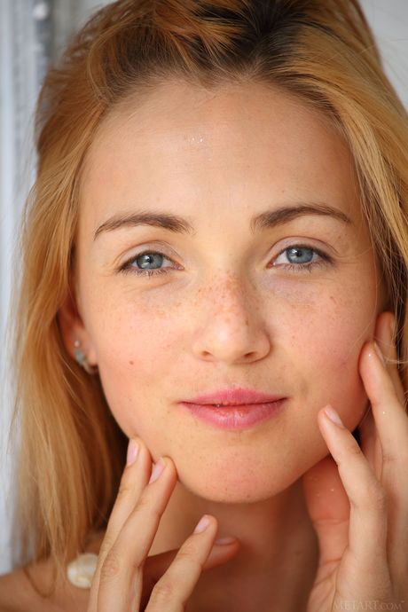 Delicate teen Renata removes her dress and presents her tiny tits and twat