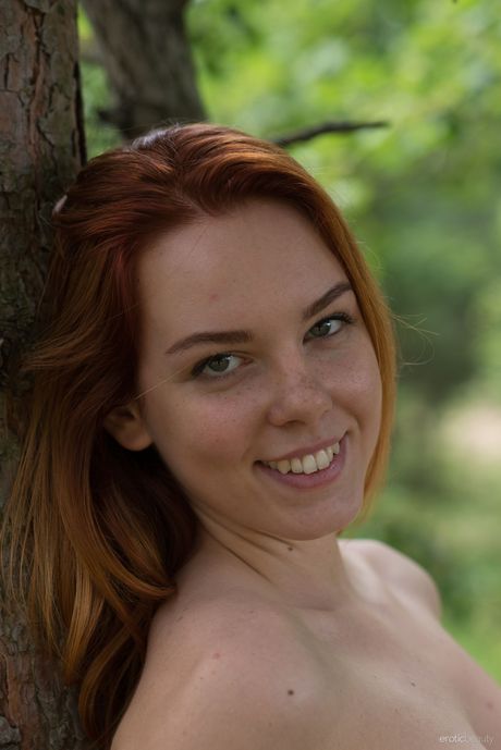 Cute teen Candy Red strips in the countryside & shows her big tits & bald pussy