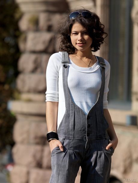 Slender teen Jackie D smokes a cigarette while posing nude in a leather jacket