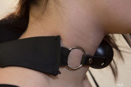 Teen model Ruta removes a ball gag and pantyhose to get naked on a bed