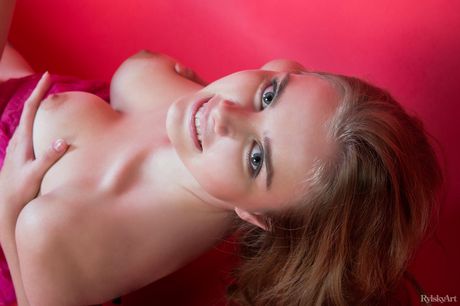 Young redhead Marit displays her firm boobs in sexy hosiery