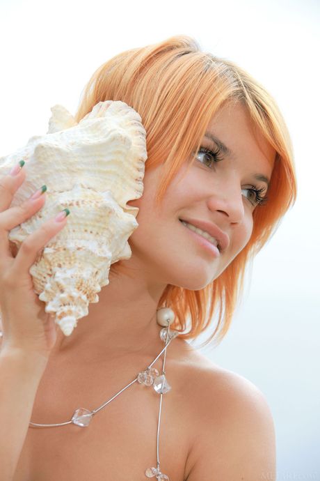 Sexy redhead Violla A presents her big tits & exposes herself on the beach