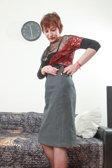 Mature redhead Sofia K shows her big ass and poses in her glasses