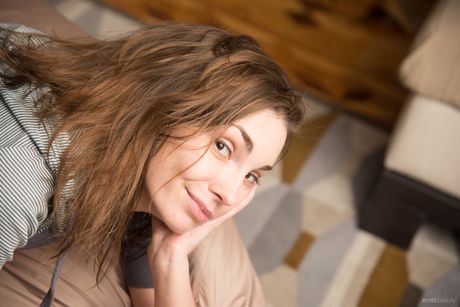 Young brunette Mila H gets completely naked on a bean bag chair