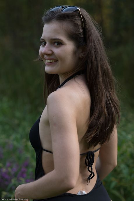 Charming teen Pola strips naked in the backyard and shows her bald pussy