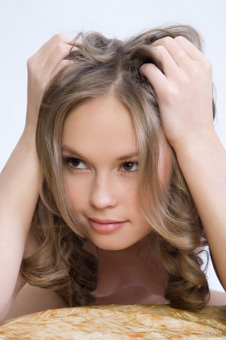 Blonde teen Caesaria A displays her hairy pussy in the nude