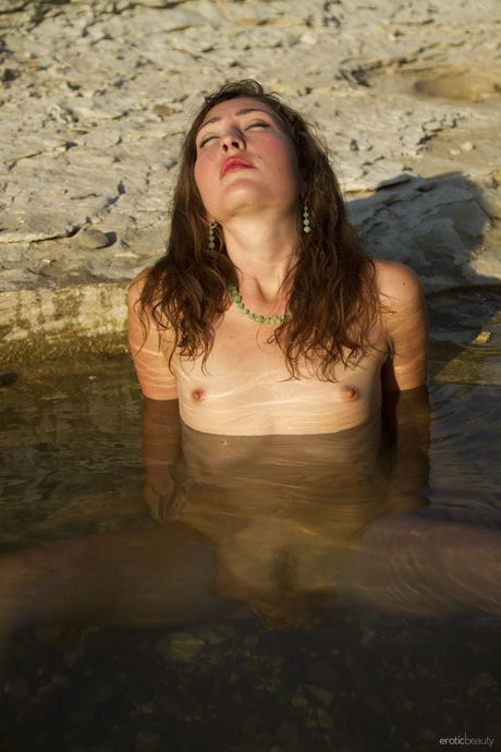 Russian beauty Alana Jaya gets naked in a shallow pool of water