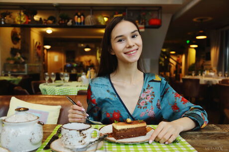 Russian beauty Leona Mia gets naked while eating a cake in the living room