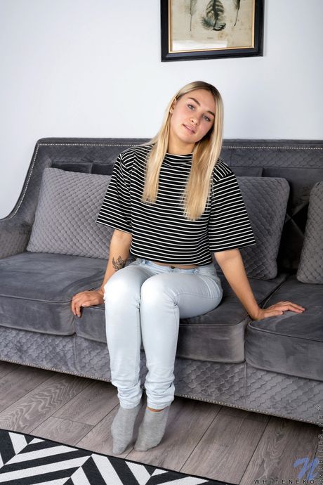 Blonde girl Whiteneko bares it all on a sofa in white socks