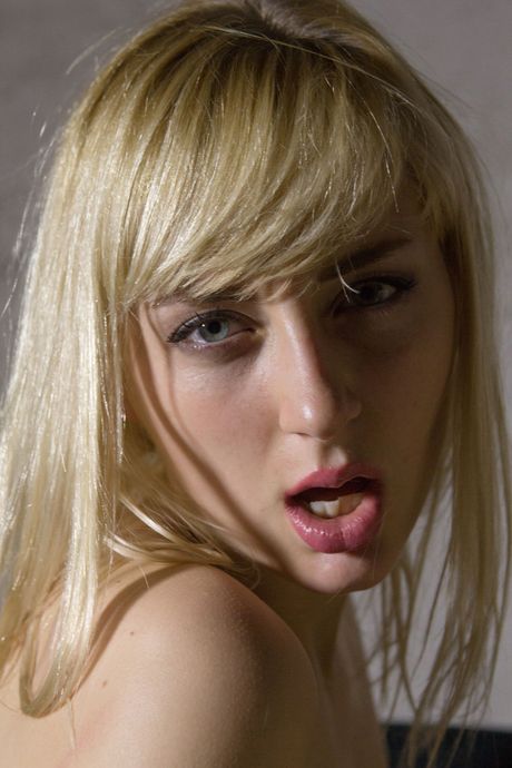 Blonde teen Vera O removes black lingerie before masturbating in over the knee boots