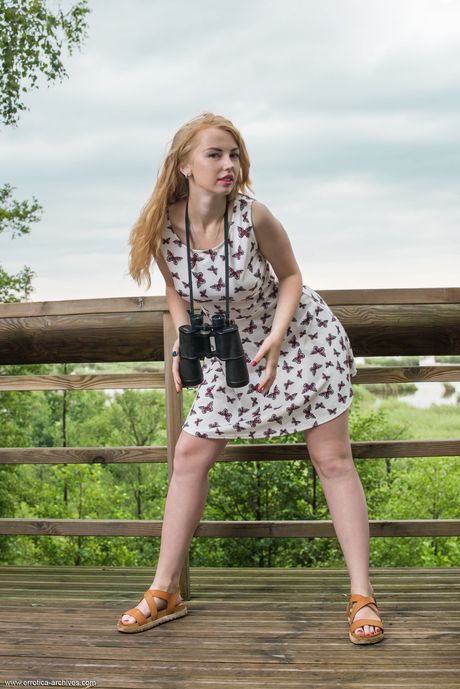 Young redhead Helene goes naked on a patio in sandals