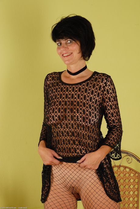 Sexy MILF Eve strips and shows her big ass and pussy in fishnet pantyhose