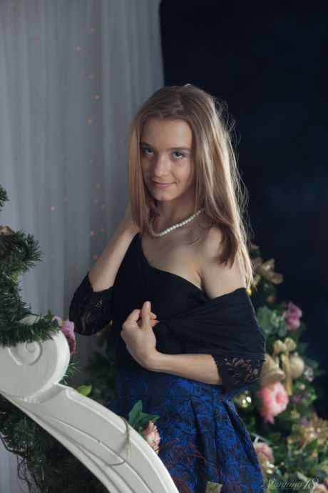Blonde teen Avril A gets naked in white socks and a bow tie