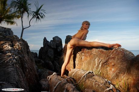 Young beauty Electra goes naked on a sandy beach