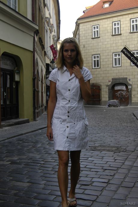 Blonde teen Iveta B flashes her bald pussy before getting naked in public