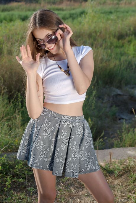 Stunning teen Hrizantema strips in the field & shows her big tits & bald pussy