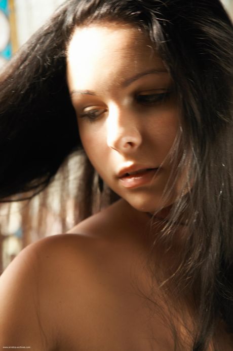 Naked teen girl with long hair and a nice ass poses in the nude