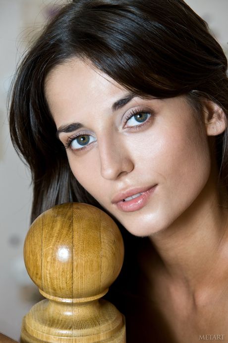 Delicate teen Irina B strips naked and poses on a bed in a solo