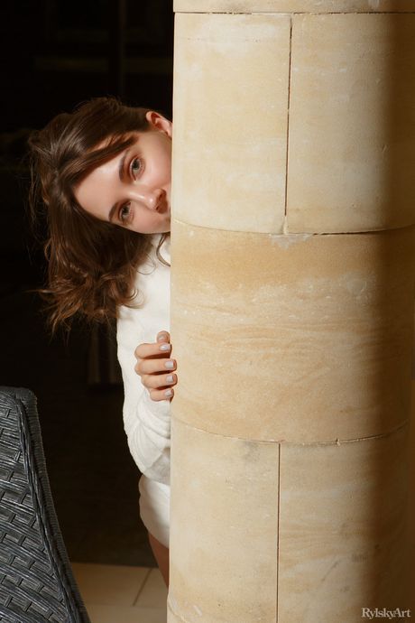 Busty teen Danniela displays her big tits and poses naked on the floor