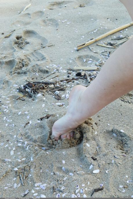 Blonde teen Candice Demellza models totally naked on a beach