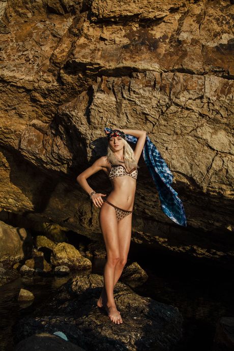 Ukrainian blonde Nika N masturbates while posing naked on a rocky beach