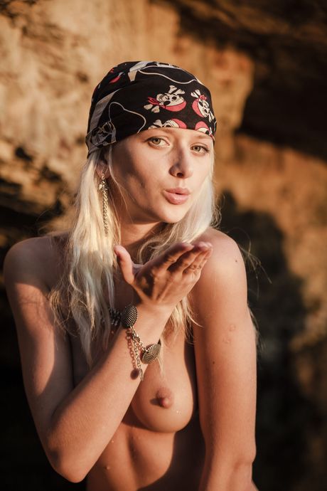 Ukrainian blonde Nika N masturbates while posing naked on a rocky beach