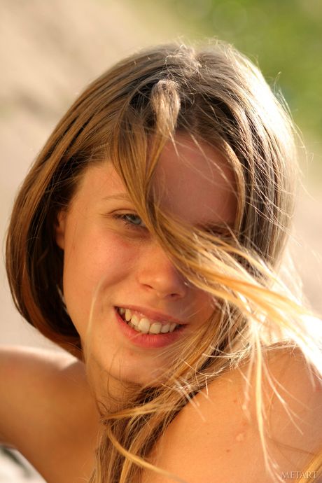 Russian belle Kate B models totally naked on a beach in the sand