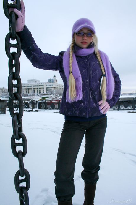 Barely legal girl Olya N gets naked in a snowbank while wearing glasses