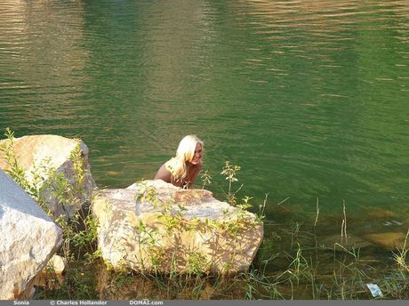Blonde teen Sonia models totally naked on a sandy beach by herself