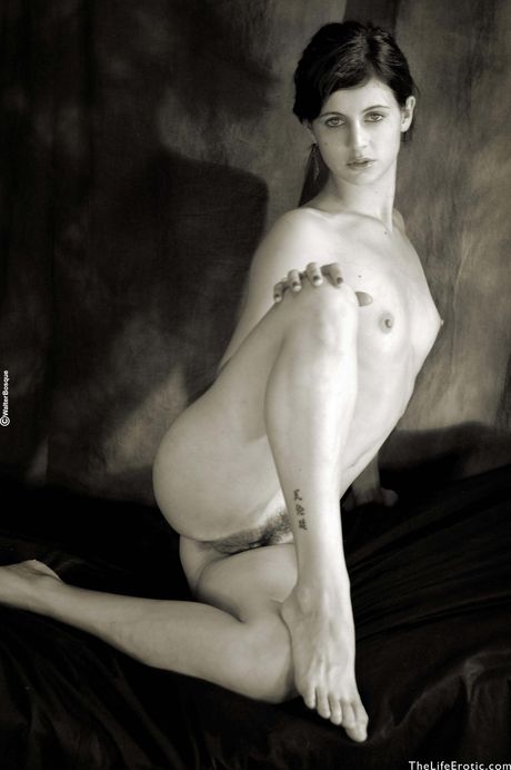 Tattooed teen Muriel shows her flexibility and poses nude in a solo