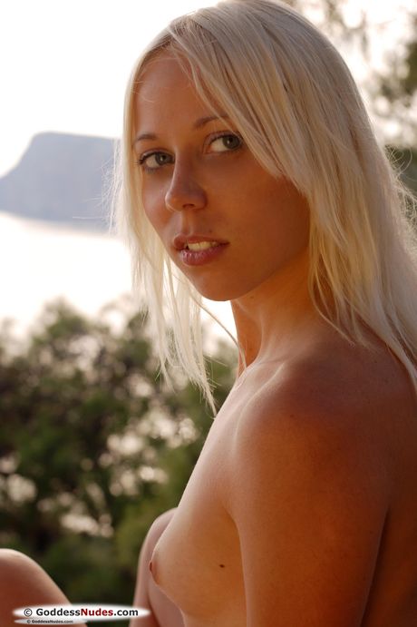 Blonde teen Tasaria models totally naked in a field of tall grasses