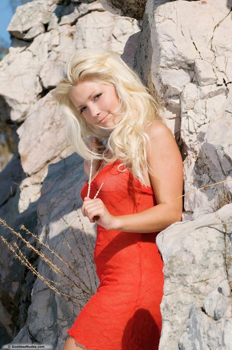 Blonde teen Anastasya gets naked on a blanket in a backyard during solo action