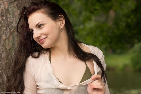 Thin teen Lisa Musa removes her bikini to pose nude on a tree