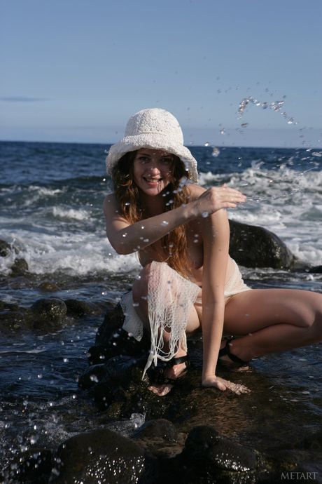 Lean teen Nastya E presents her hot ass & small tits in the ocean