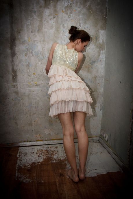 Young redhead Lilly C fingers her pussy after getting naked on a bed