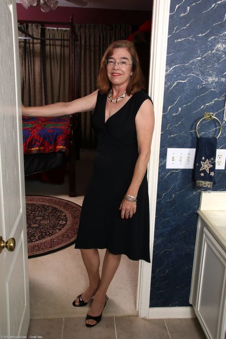 Mature secretary Melody Garner shows off her big tits & spreads her mature pussy