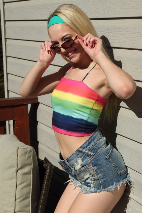 Svelte teen Lily Larimar gets naked and toys her pussy outdoors