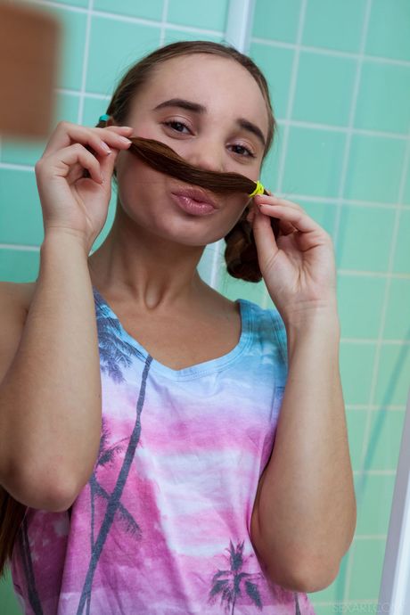 Teen model Messiah removes her clothes before masturbating in a bathtub