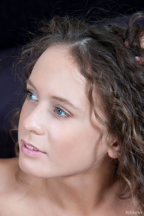 Elisandra reveals her big tits and hairy pussy as she poses in the bedroom